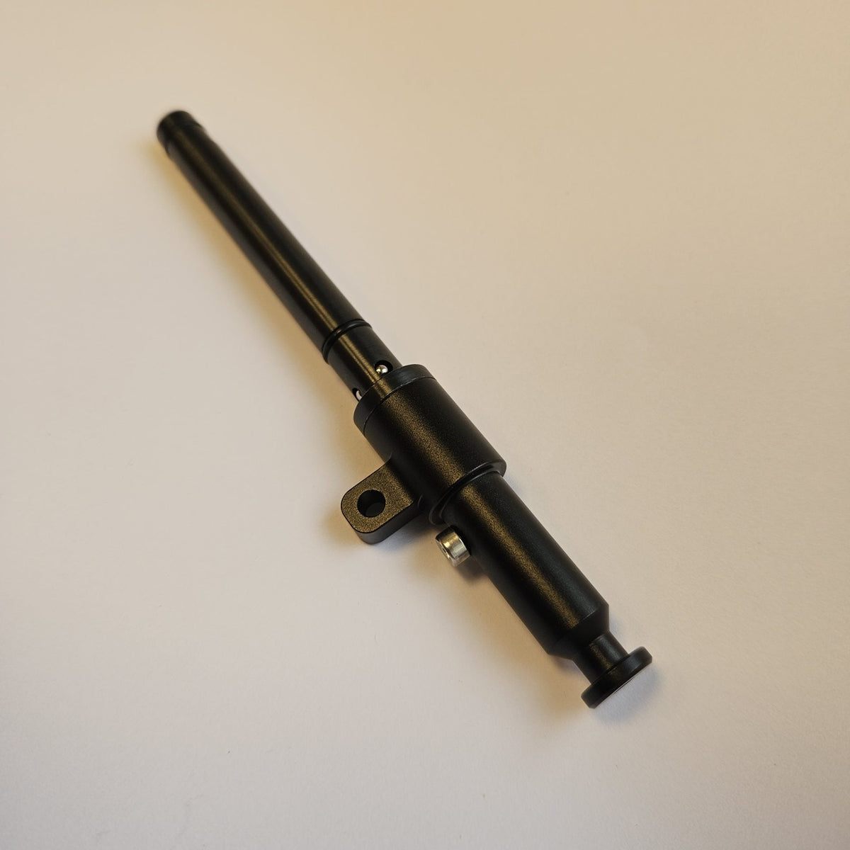 Sauer 404/505 Valhalla spigot adapter on a white surface, showing the sling attachment and retaining ball bearings