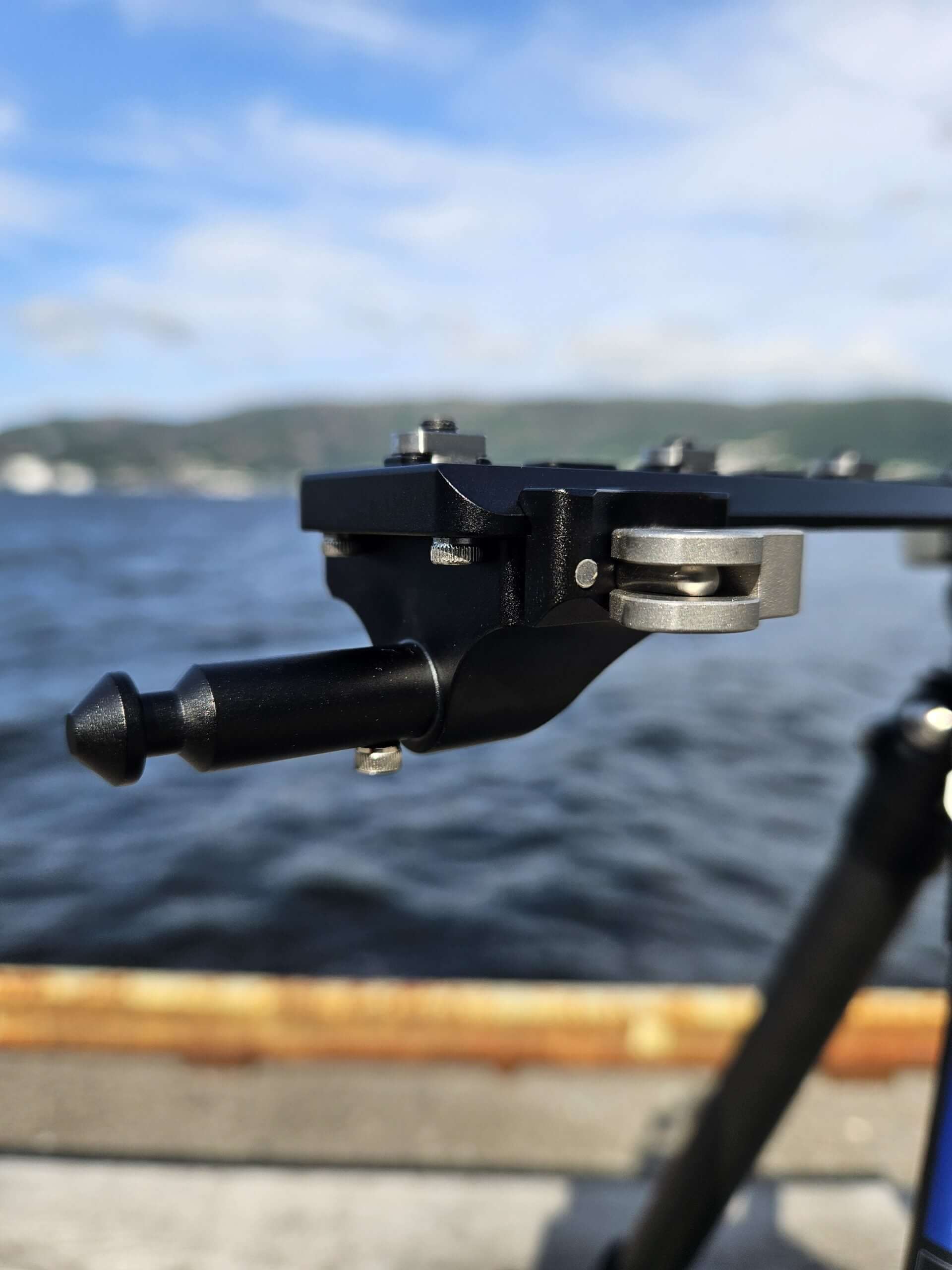 QD Arca to Valhalla Spigot adapter mounted on a tripod near a body of water.