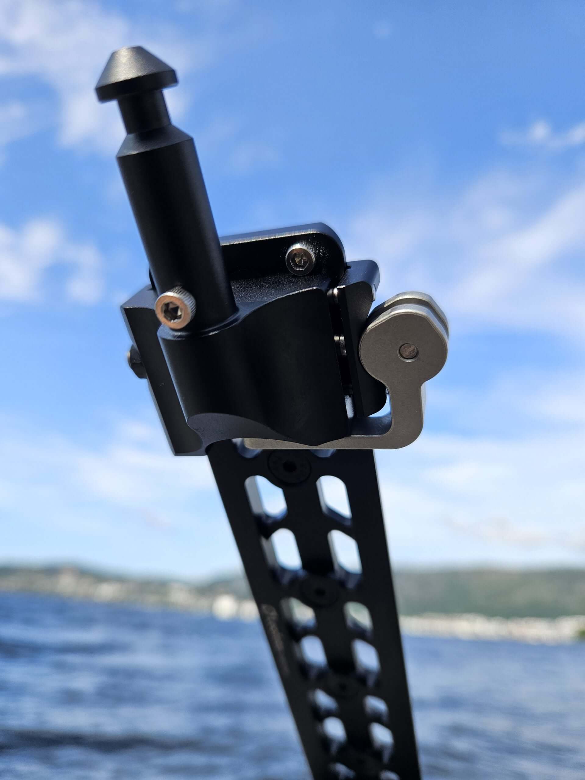 QD Arca to Valhalla Spigot adapter displayed against a scenic lake background.