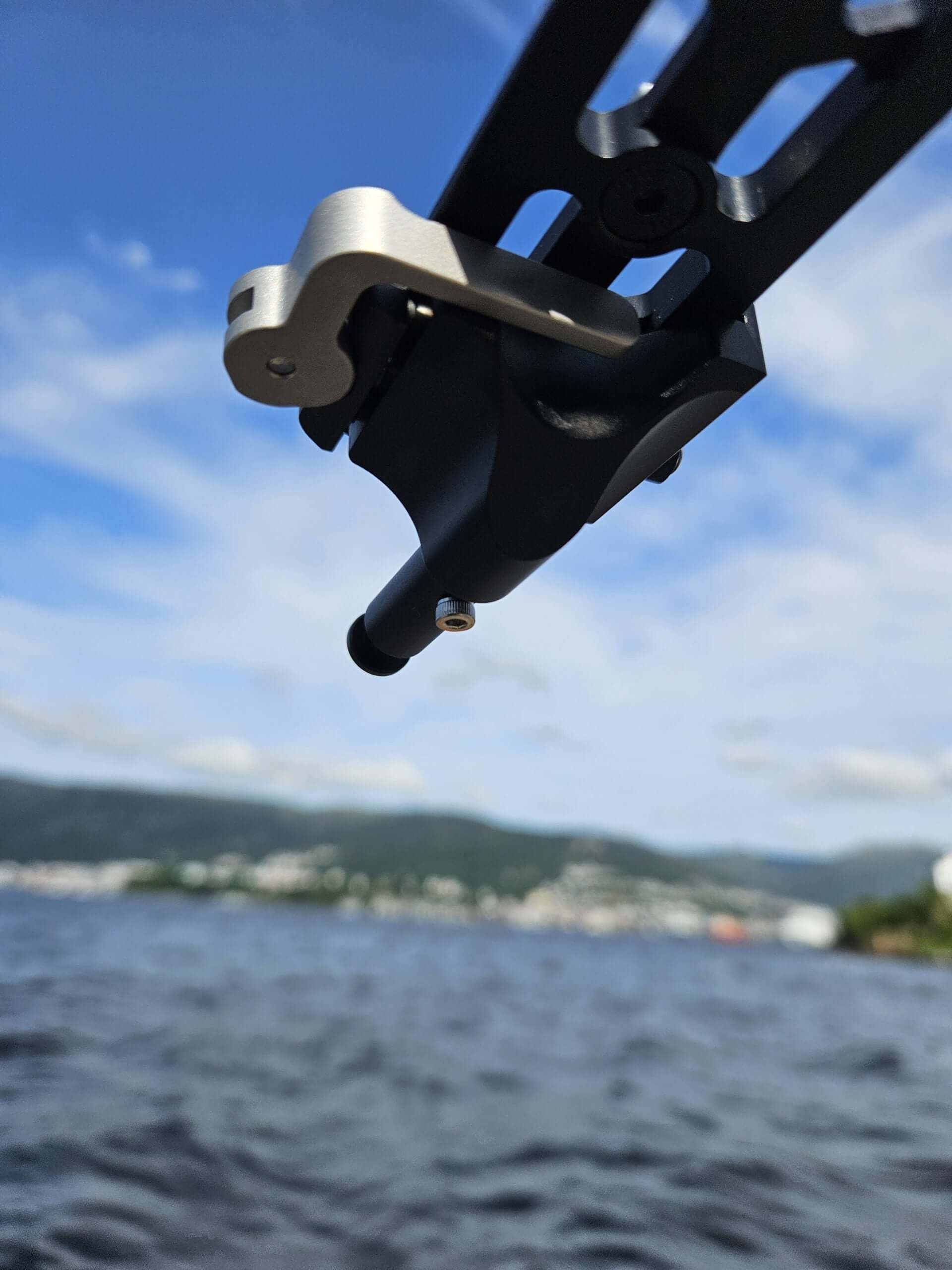 QD Arca to Valhalla Spigot adapter showcasing its premium design against a scenic lake backdrop.