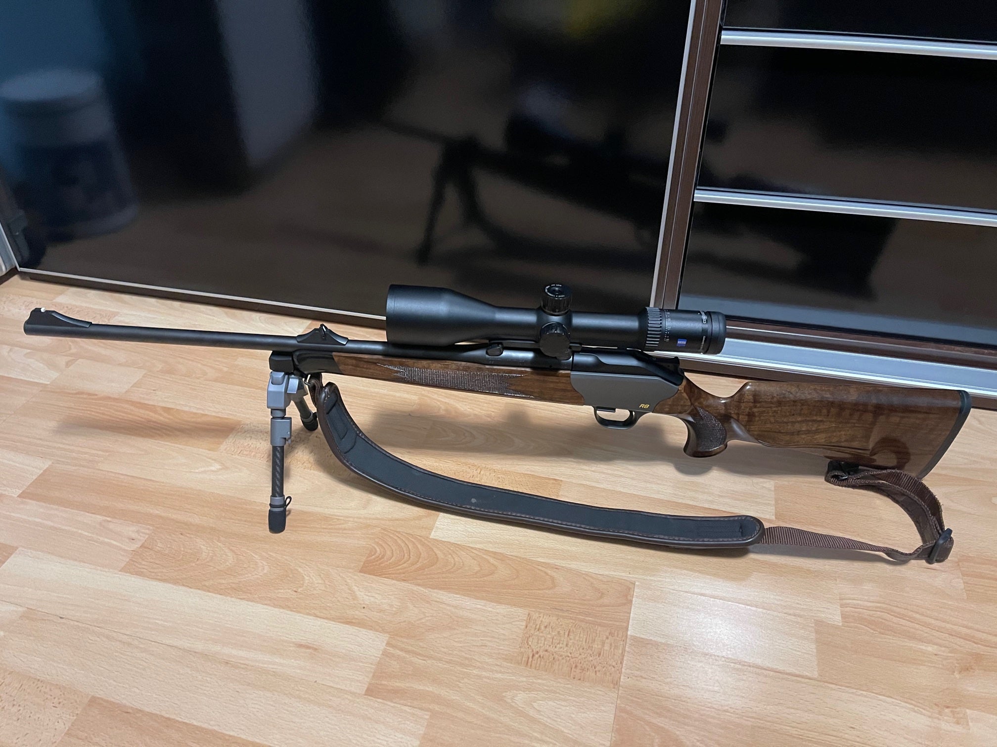 Blaser R8 Professional Adapter for Spartan Javelin bipods mounted on a rifle with scope and bipod.