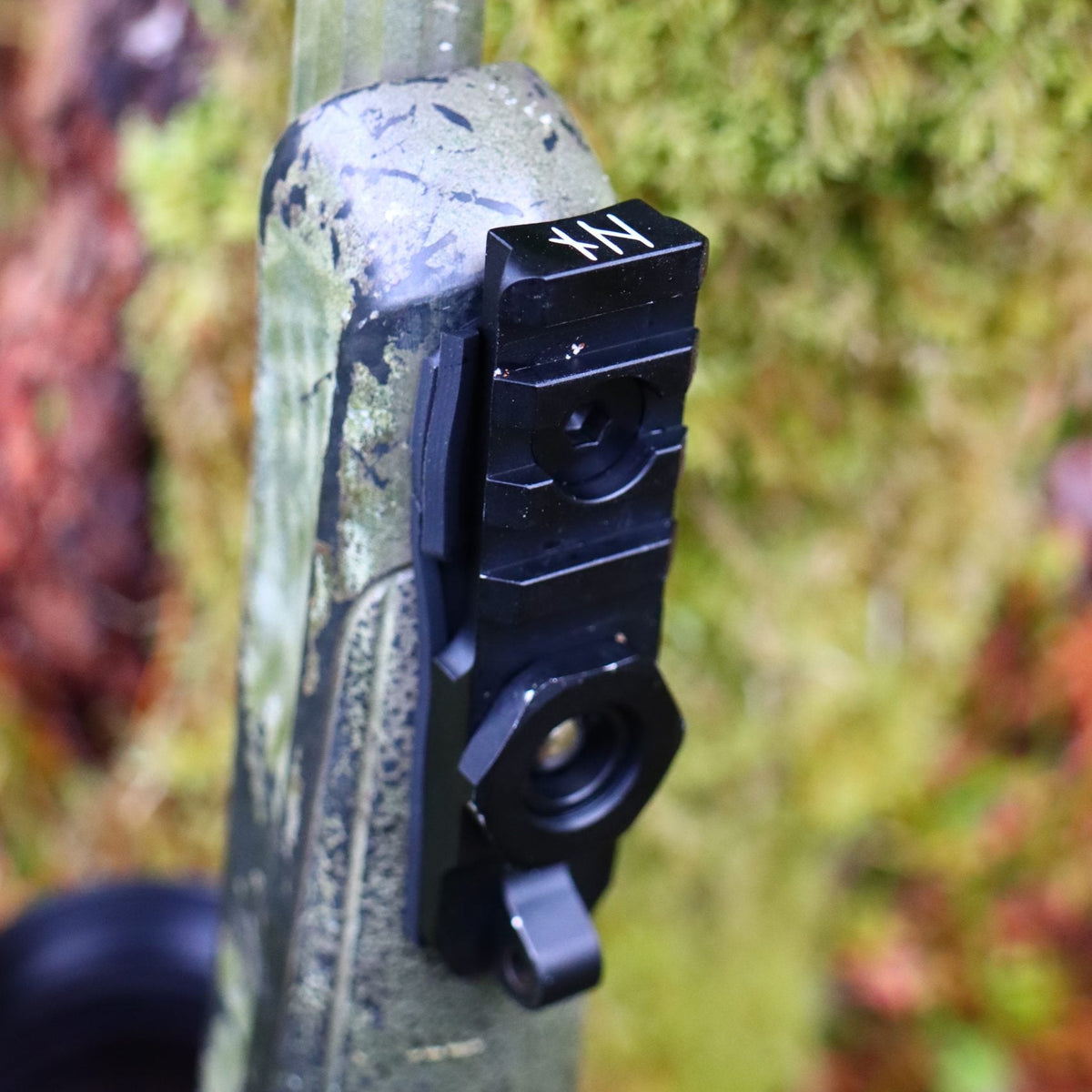 NorneHunt Sling Stud Picatinny rail mounted beneath a camouflage rifle fore-end, viewed from underneath.