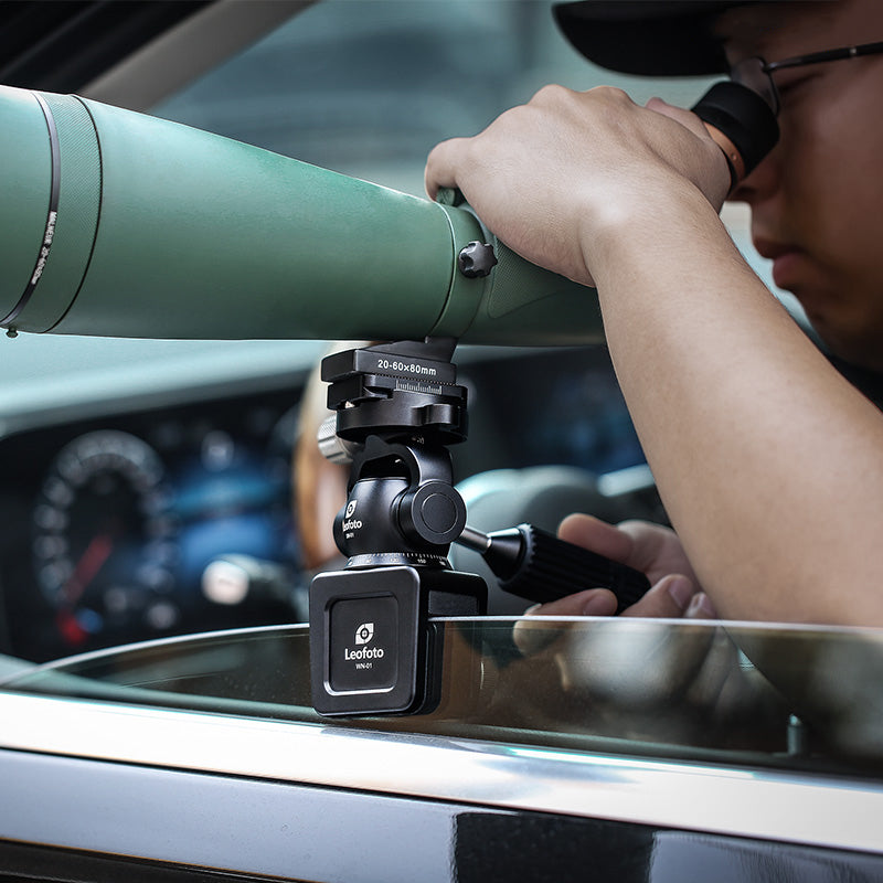 User utilizing WN-01+SW-01 car window clamp kits with a spotting scope for steady shooting.