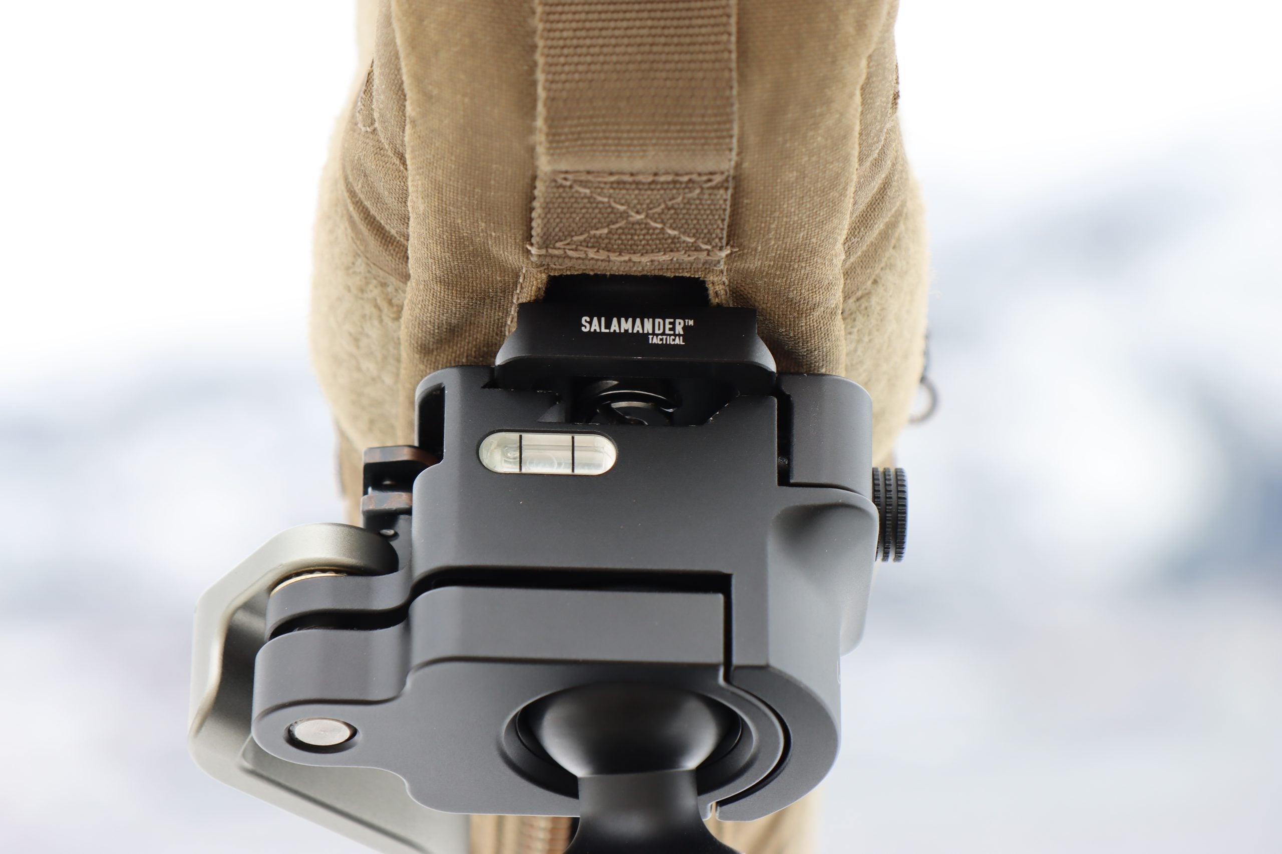 Arcaplate with anti rotation pin for spotting scope mounted on tripod showing secure connection and stability.